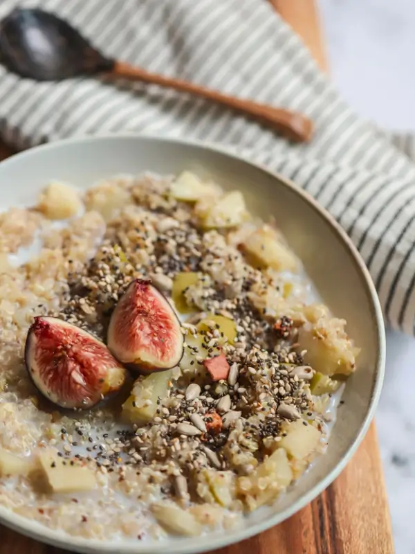 Quinoa porridge topped with seeds and fresh fruit