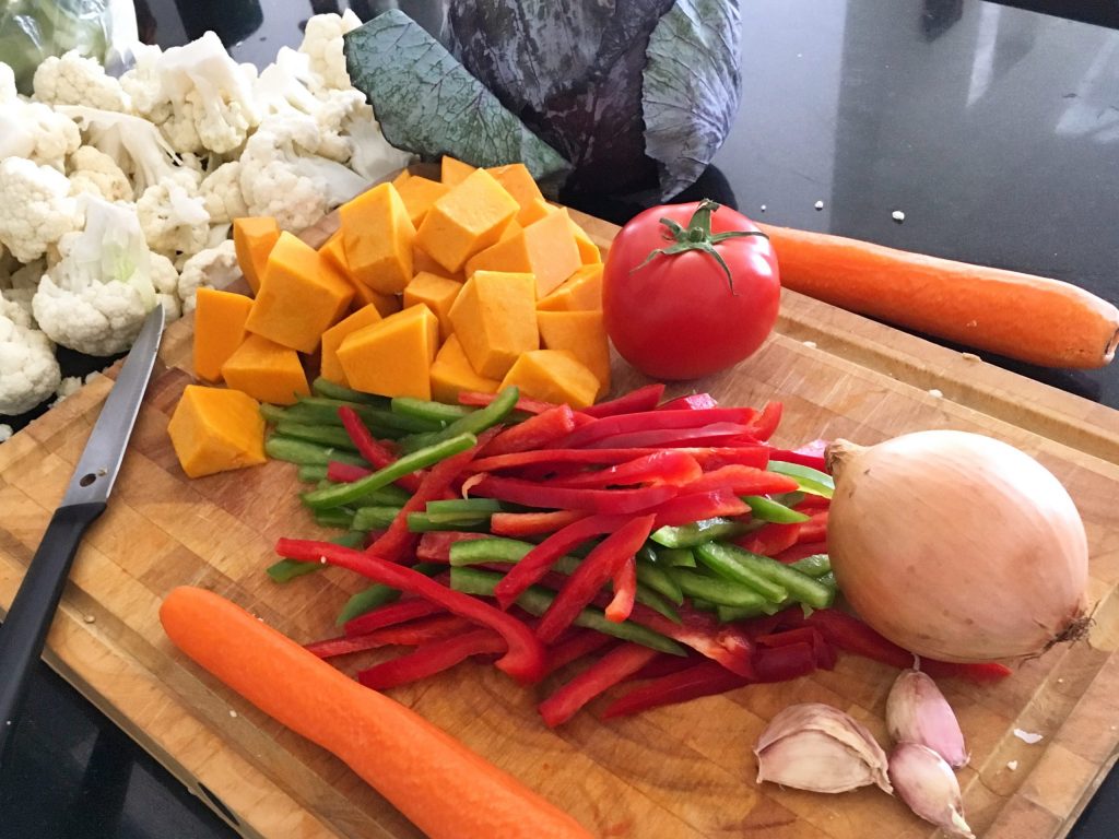 Vegetables being chopped on a chopping board