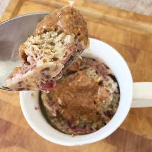 Brekkie mug with almond butter, spoon close up
