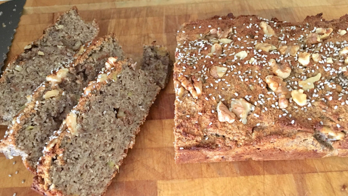 Banana walnut bread sliced on a chopping board