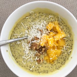 Mango chia pudding topped with fresh mango and coconut flakes