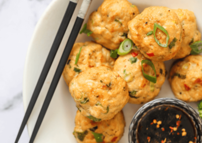 Chicken miso meatballs in a bowl with chopsticks and dipping sauce