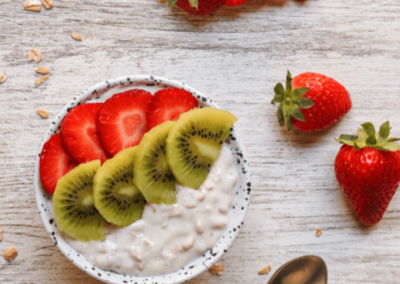 Vanilla pudding bowl topped with strawberry and kiwi slices