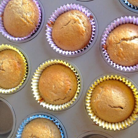 close up from above of fruit muffins in a baking tin