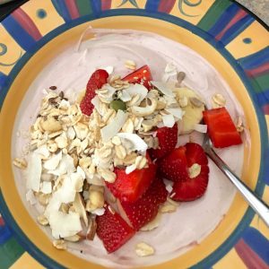 Acai bowl topped with muesli and strawberries
