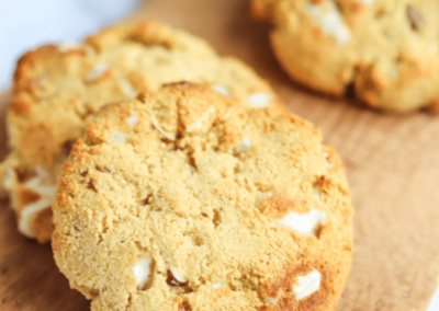 Almond white chocolate protein cookies on a board