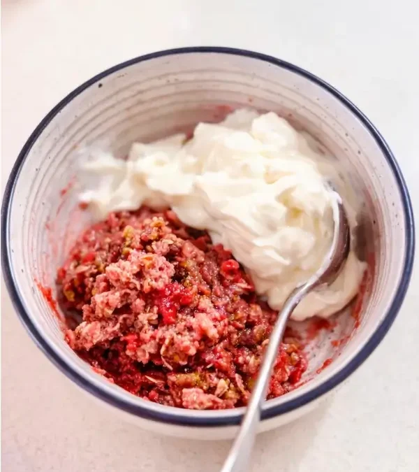 Raspberry crumble in a bowl with Greek yoghurt on the side