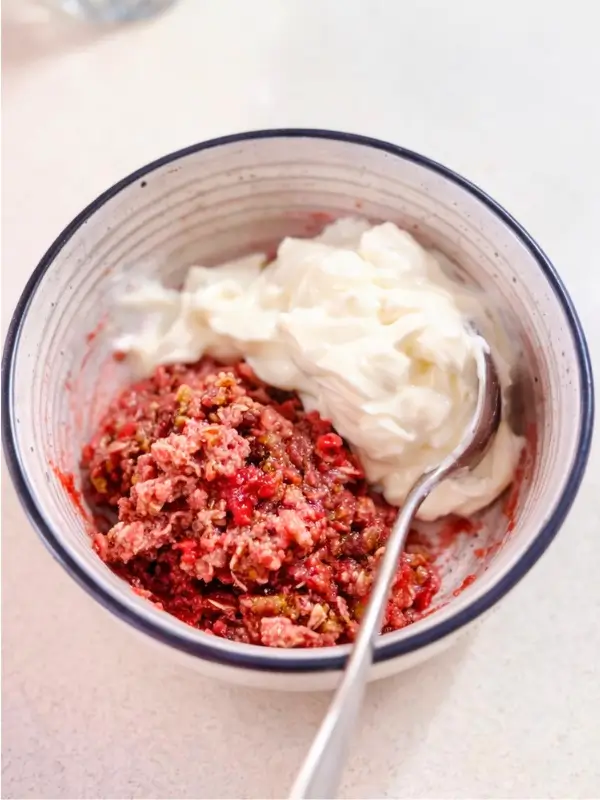 Raspberry crumble in a bowl with Greek yoghurt on the side