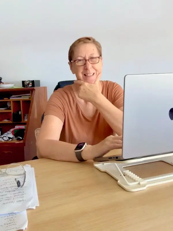 Wendy working on her laptop at her desk