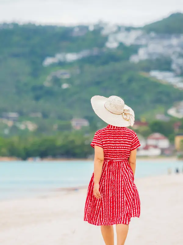 rear view of a woman walking on the beach