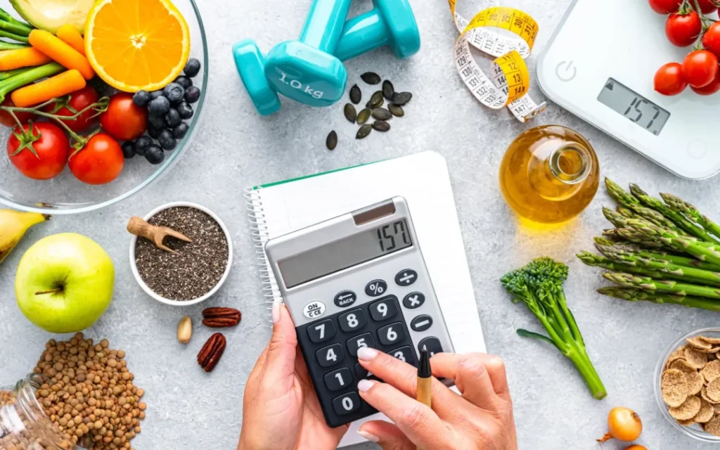 healthy ingredients on a bench with dumbbells, scales and a calculator