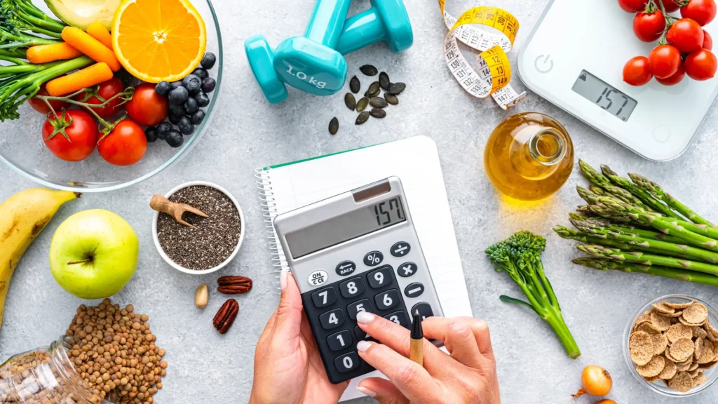 healthy ingredients on a bench with dumbbells, scales and a calculator